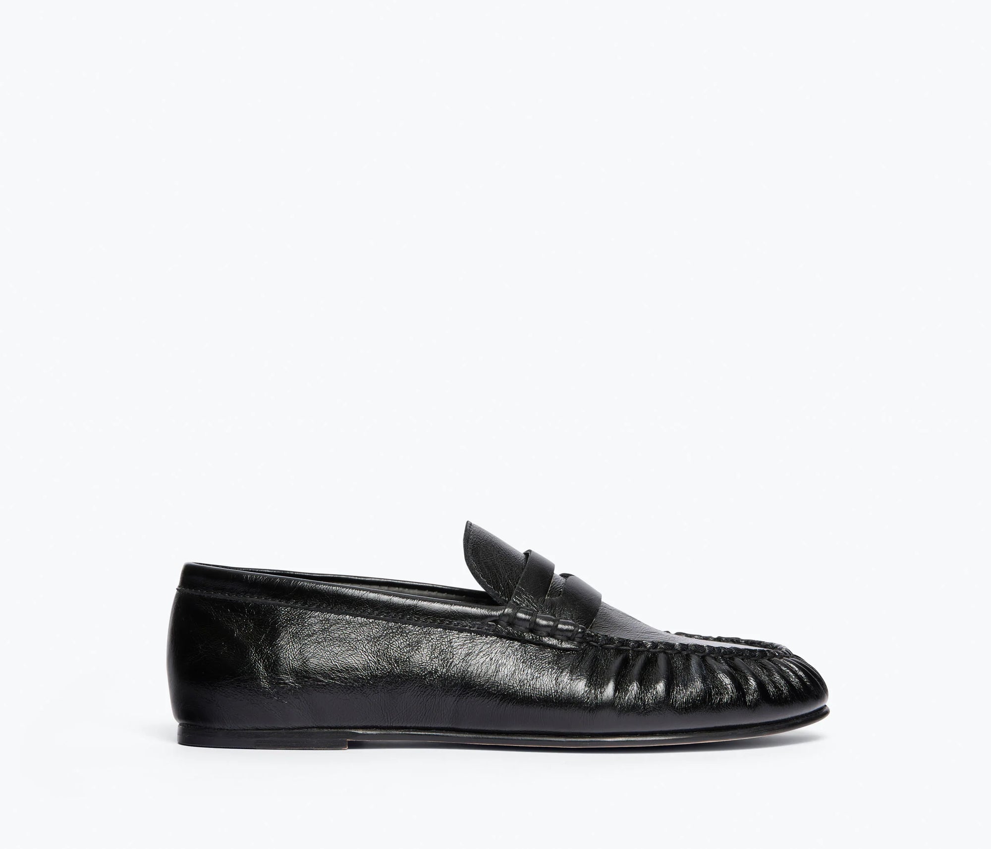 The Freda Salvador Sydney Crinkle Loafer, a black Italian leather shoe with a penny strap and moccasin-style stitching, is shown in profile against a plain white background.
