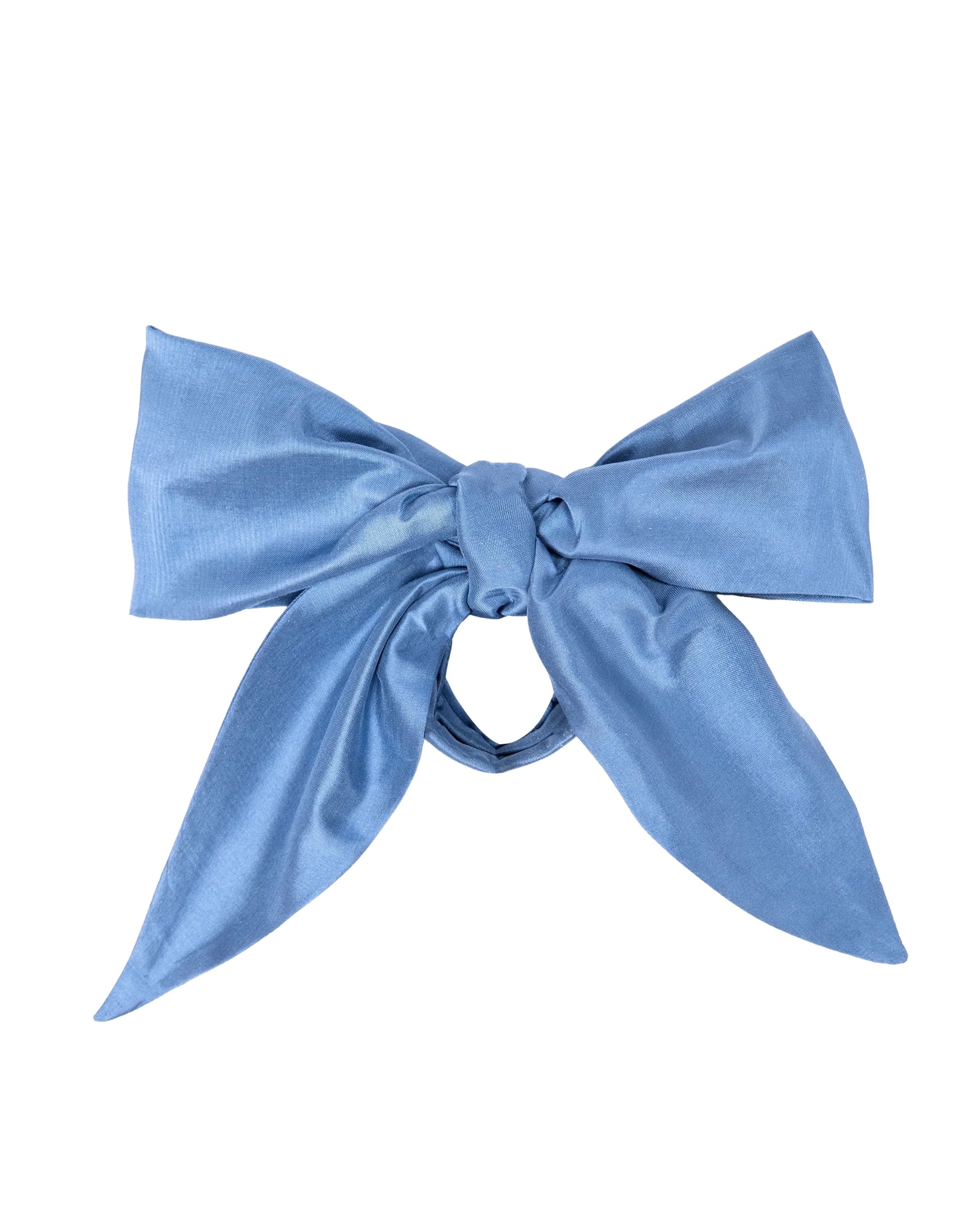The Taffeta Bow Cornflower Blue by Donni is a large, neatly tied light blue taffeta accessory with long, wide tails, displayed against a plain white background.