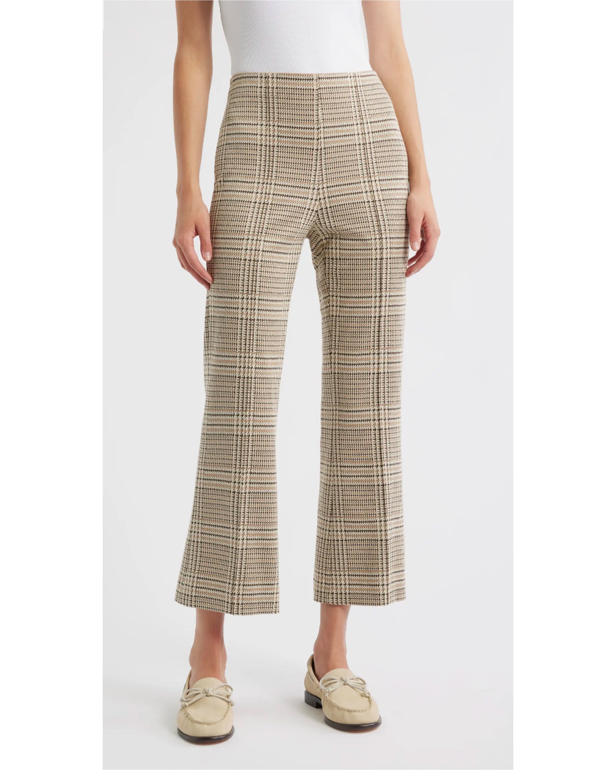 Wearing Rag & Bone’s irina ponte kick flare in beige and brown plaid with a white sleeveless top and cream loafers, this look against a white background is effortlessly chic—ideal for transitioning from office to evening.
