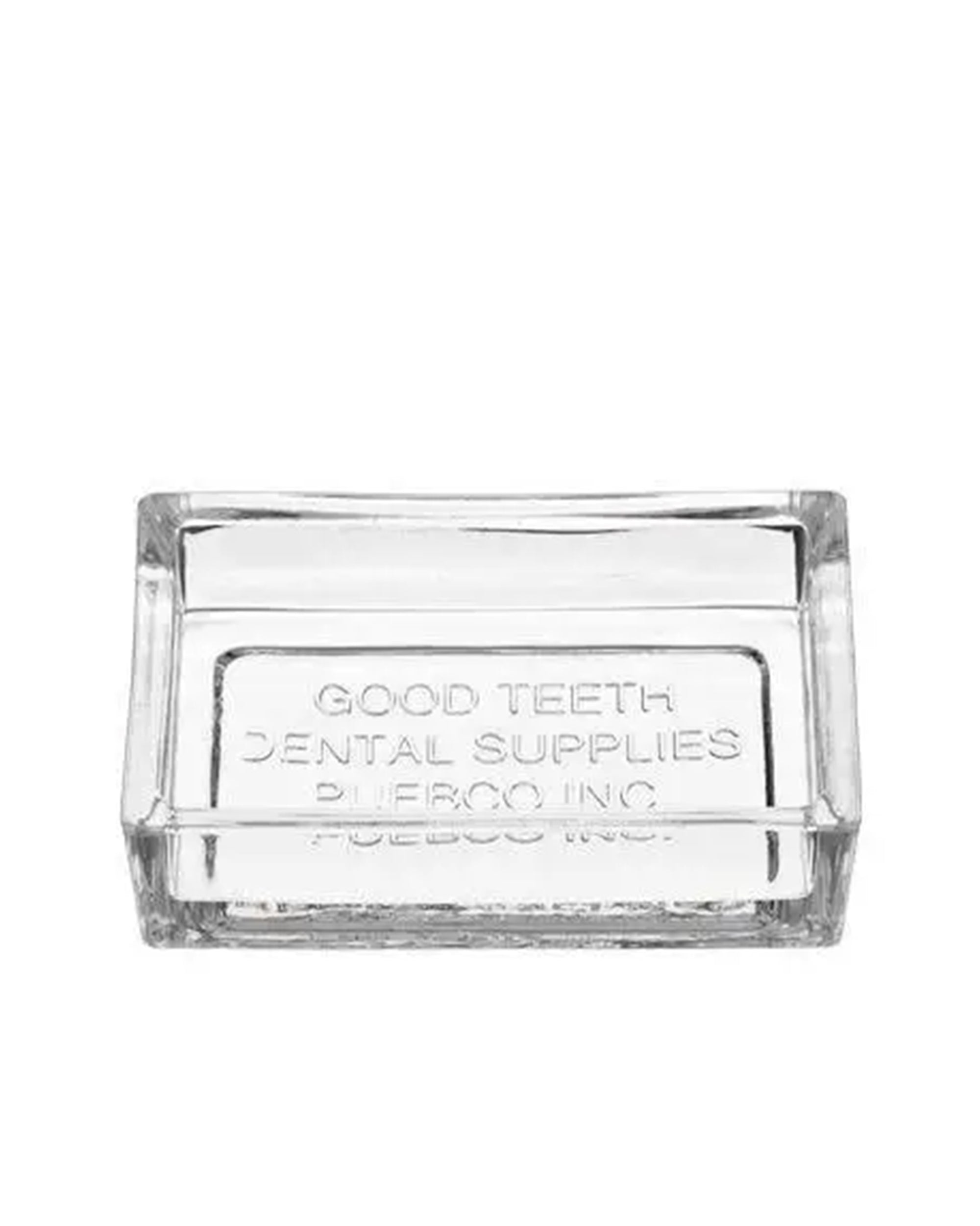 The Faire Dental Tray is a clear rectangular recycled glass piece with "GOOD TEETH DENTAL SUPPLIES PUEBCO INC." embossed on the bottom—a vintage-inspired bathroom accessory.
