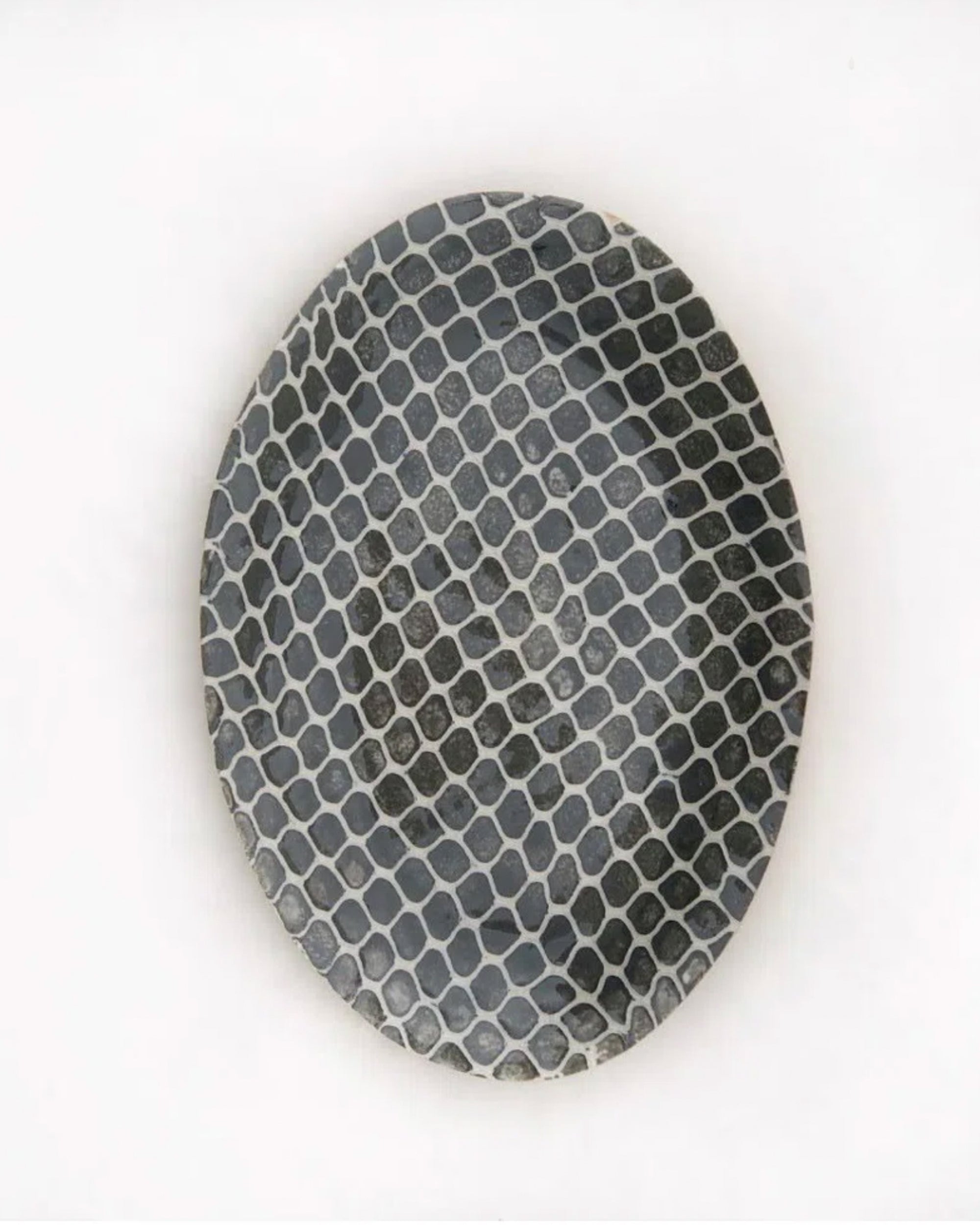 The Petite Oval by Terrafirma Ceramics is a stoneware plate featuring a black and white honeycomb pattern on a plain white background. Dishwasher safe for easy cleaning.