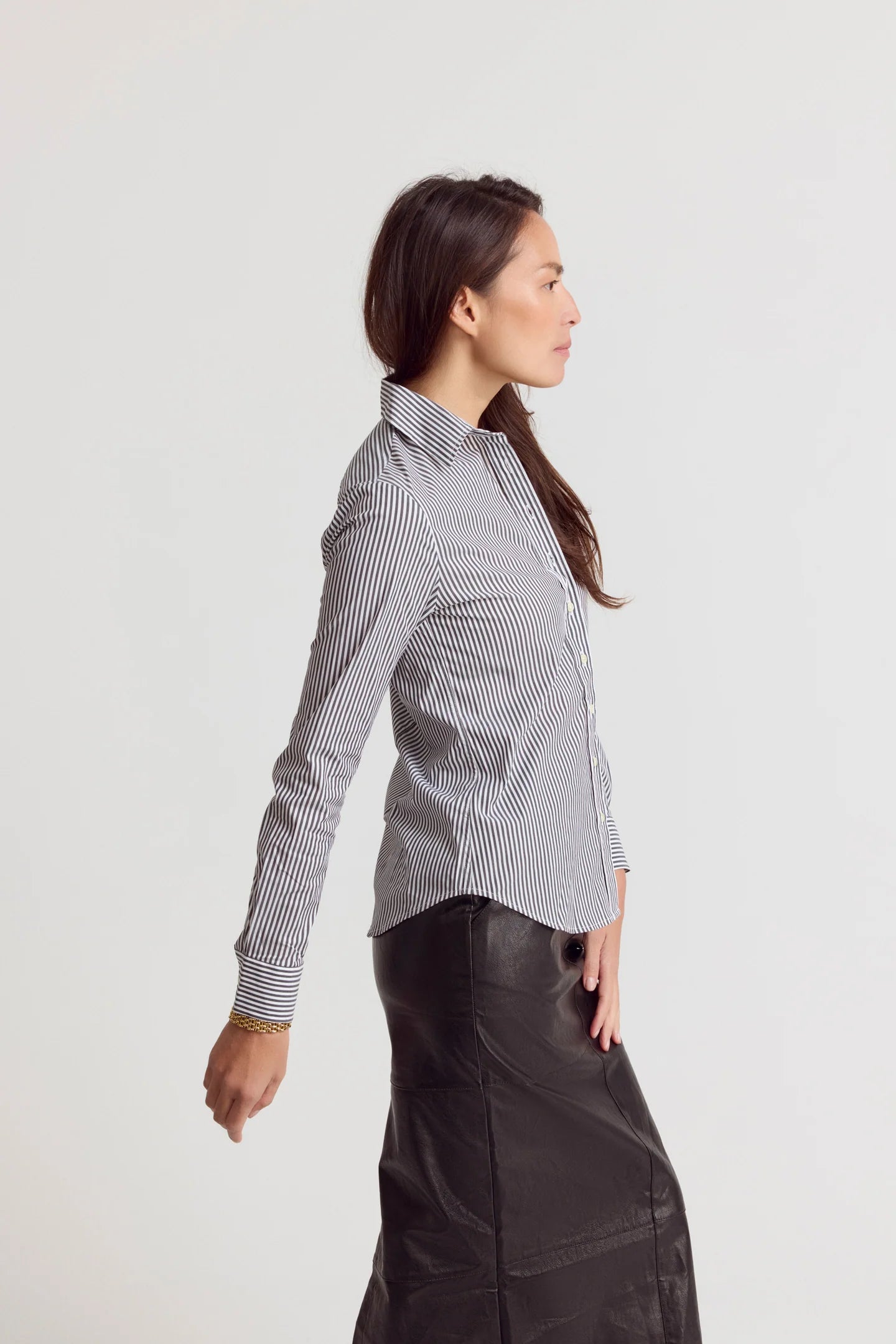 Striped Icon Shirt by THE SHIRT paired with black skirt, shown in profile against a white background.