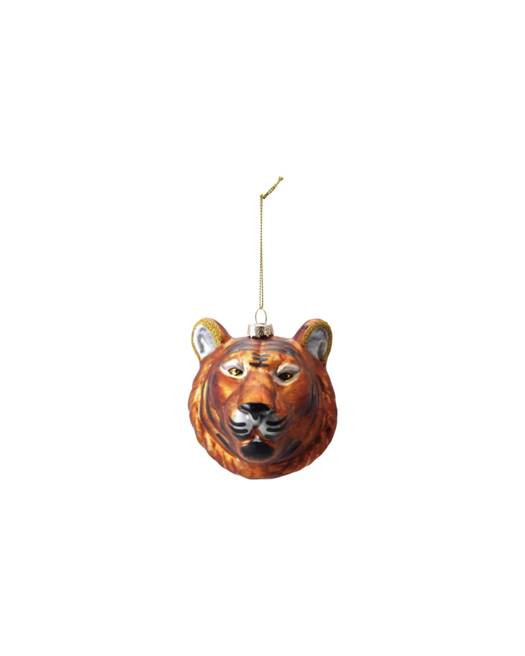The Creative Co-op Glass Tiger Head Orange ornament, featuring glitter accents and a gold hanging string, is shaped and painted like a tiger's head and displayed against a white background.