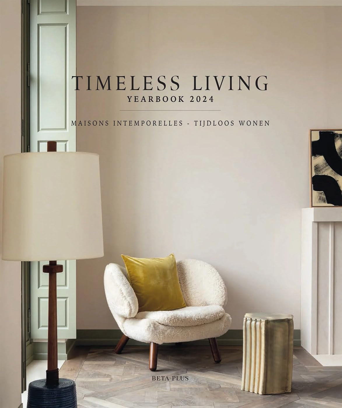 Cover of the National Book Network&#39;s &quot;Timeless Living Yearbook 2024&quot; featuring a minimalistic room with a stylish chair, a floor lamp, artwork, and accent items in a serene Arizona color palette.