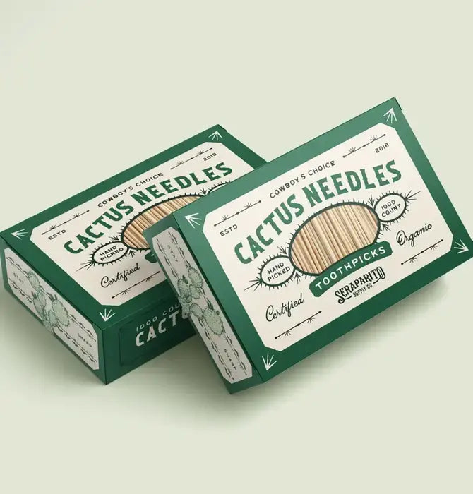 Two green-and-white boxes of Faire’s Cactus Needle Toothpicks, featuring vintage designs and organic bamboo picks. Hand-picked in Mexico, these make a unique Southwest souvenir.
