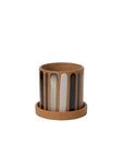 The Truman Pot/Saucer 6x5.5" by Accent Decor is a small, cylindrical ceramic pot with a matching saucer, featuring hand-painted vertical black, white, and gray drips over a natural brown base.