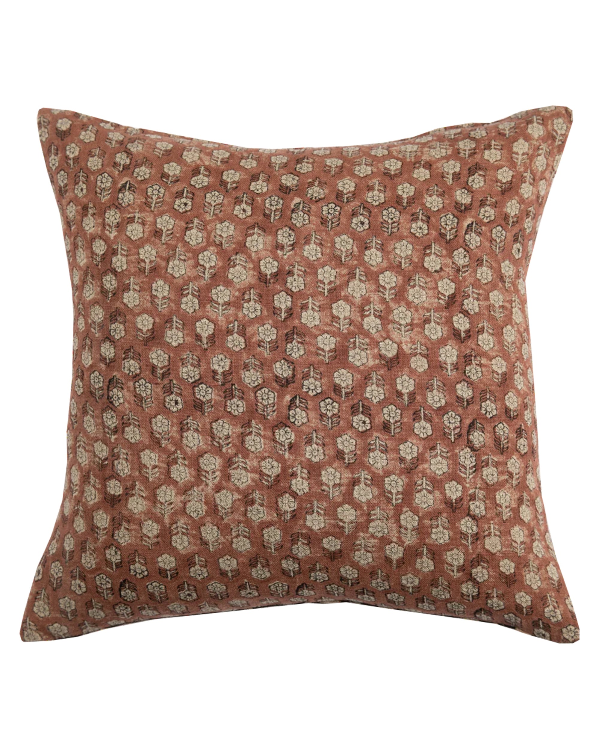 The Tulsi Saffron Pillow 24x24 by Filling Spaces LLC features a rust-colored background with a hand block-printed pattern of beige and dark brown leaf motifs, crafted in soft linen and shown on a white background.