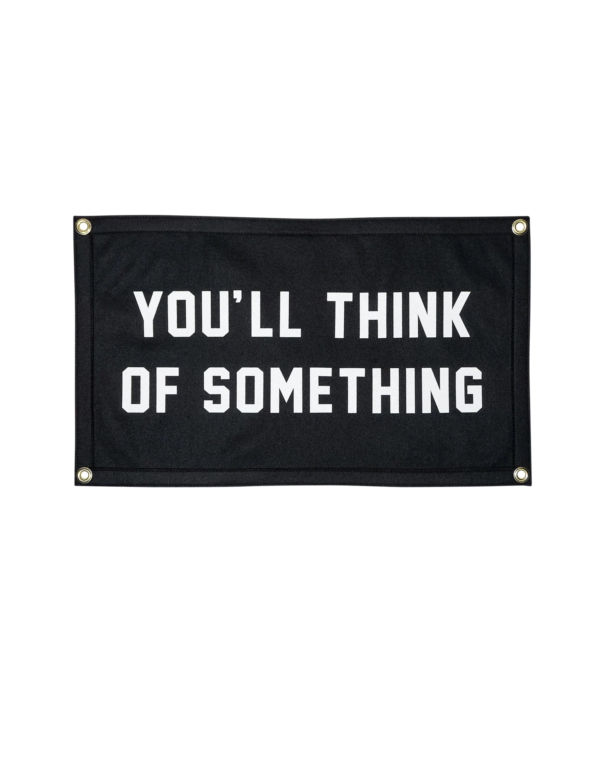 The Oxford Pennant You'll Think of Something Camp Flag 14x24 is a black rectangular flag with four metal grommets and bold white text: "YOU'LL THINK OF SOMETHING," designed to spark your creativity.