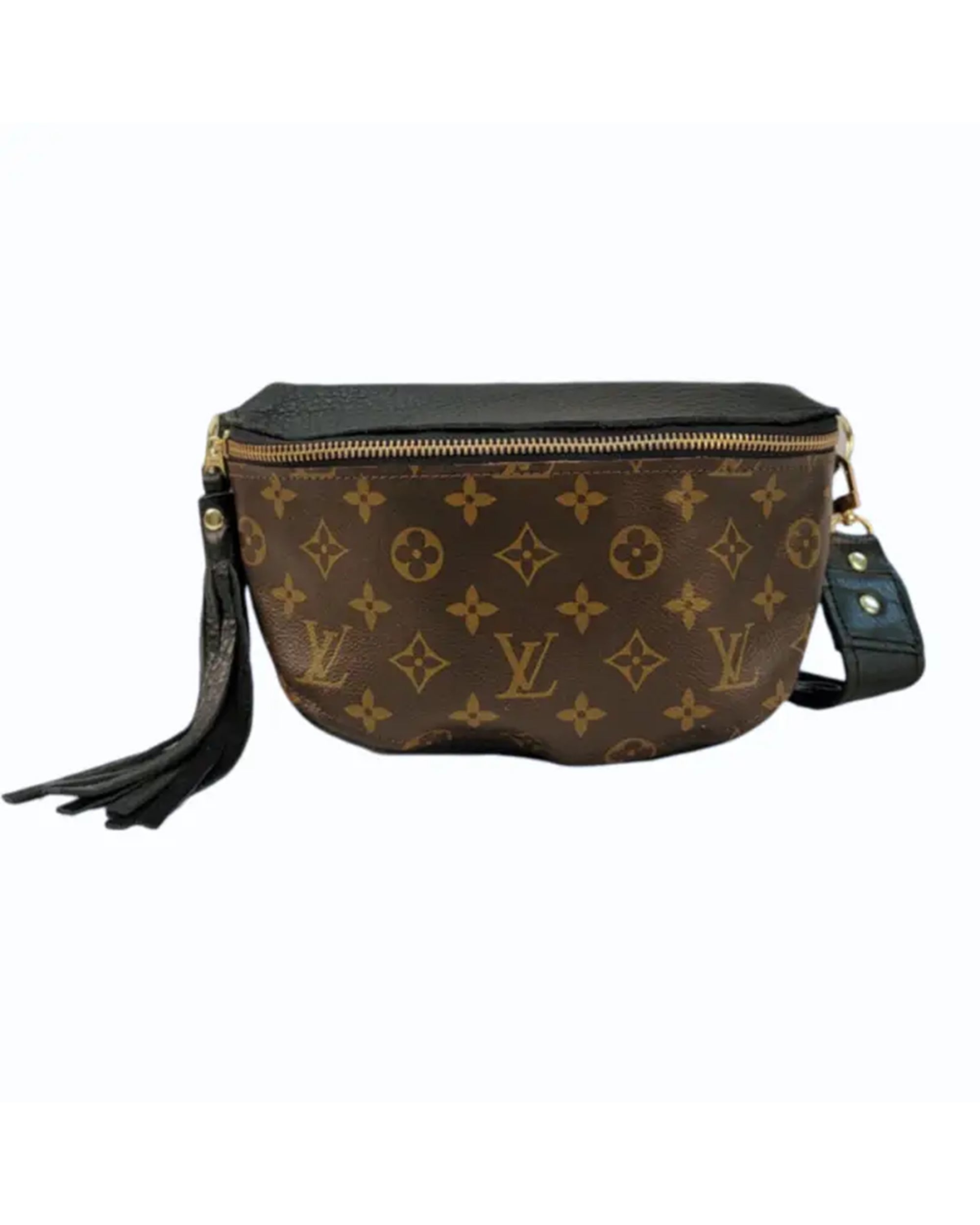 The Faire Britt Belt Bag in black leather features a gold zipper, black leather strap with gold hardware, and a black leather tassel on the side.