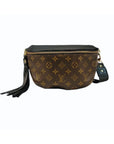 The Faire Britt Belt Bag in black leather features a gold zipper, black leather strap with gold hardware, and a black leather tassel on the side.