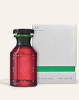 A red bottle of The Nue Co Pheremone Fragrance 50ml stands before its sleek silver and green box, both featuring minimalist modern design, emphasizing the fragrance's allure.