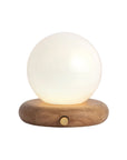 The Valencia Portable Light by Faire features a spherical frosted glass shade and rounded wooden base with a gold button, offering minimalist, modern style perfect for enhancing any contemporary space.