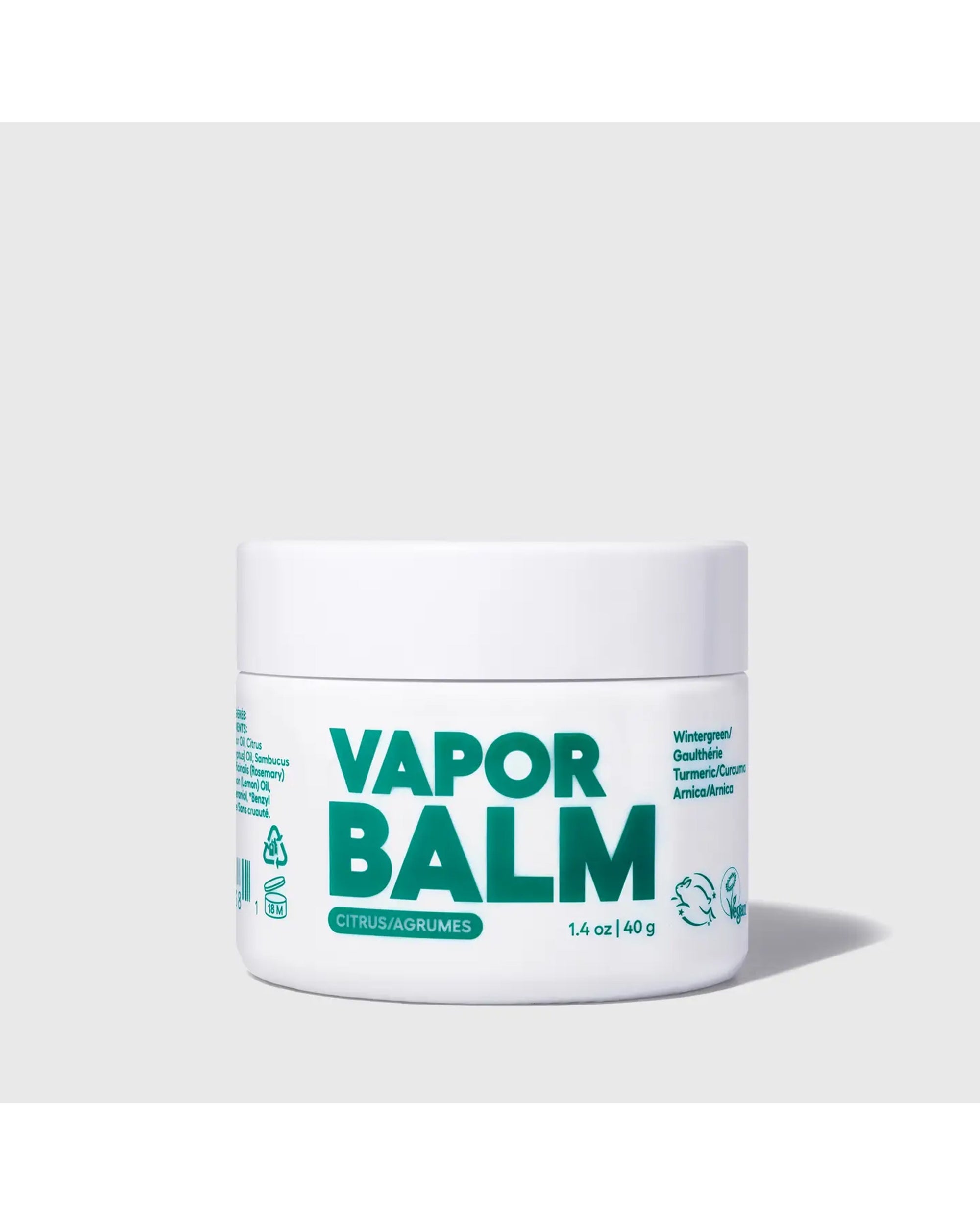 A white Faire Vapor Balm Jar with bold green labeling rests on a light gray surface, featuring "Citrus/Agrumes" and soothing ingredients like Wintergreen, Gotu Kola, Turmeric, and Arnica for chest relief.