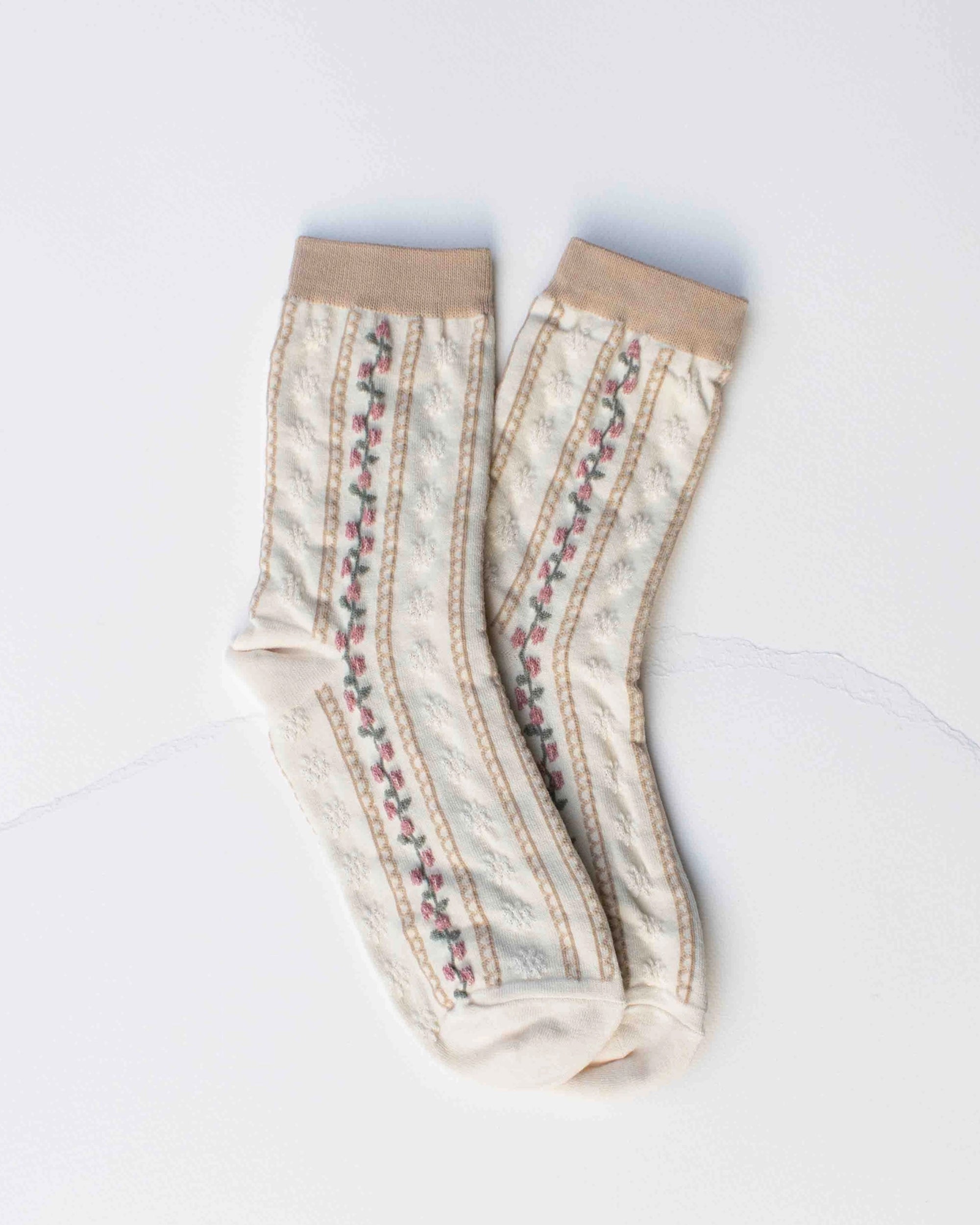 The Faire Vintage Stripe Floral Socks feature cream stripes, beige cuffs, toes, and heels, plus a vintage-inspired floral pattern with small pink flowers and green leaves.