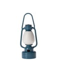 The Maileg Vintage Lantern by Maileg is a blue, vintage-style miniature lantern with a white glass center and a top handle for carrying, shown against a plain white background.