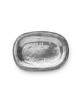 The Faire Vintage Bedside Tray is an oval, silver tray handcrafted from Italian pewter, featuring a subtly raised edge and two small rectangular hallmarks in the center. Shown on a white background, this elegant piece doubles as a stylish jewelry organizer or vintage accent for your bedside table.