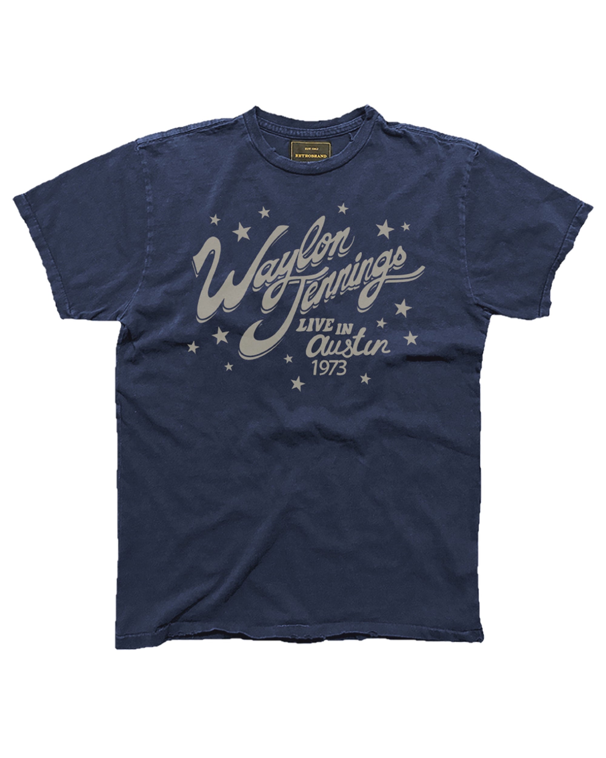 The Wildcat Retro Brands WAYLON JENNINGS LIVE AUSTIN tee features vintage navy blue fabric with white “Waylon Jennings Live in Austin 1973” lettering and small stars, giving it a classic worn look.