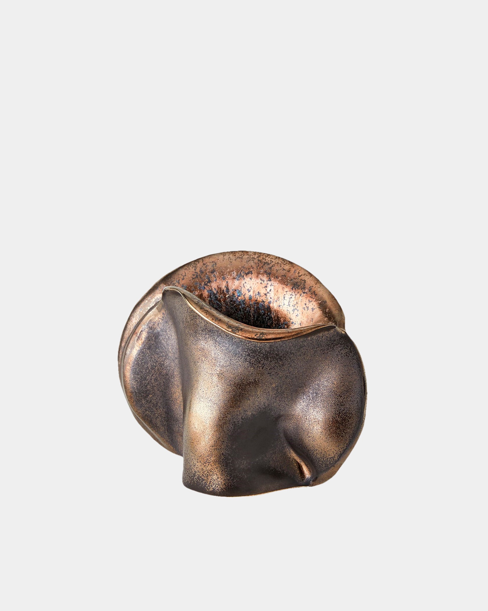 The Bocca Vase Reactive Bronze by Global Views features smooth, curved surfaces and a hollow center with a bronze reactive glaze, resembling an abstract sculpture, displayed against a plain white background.