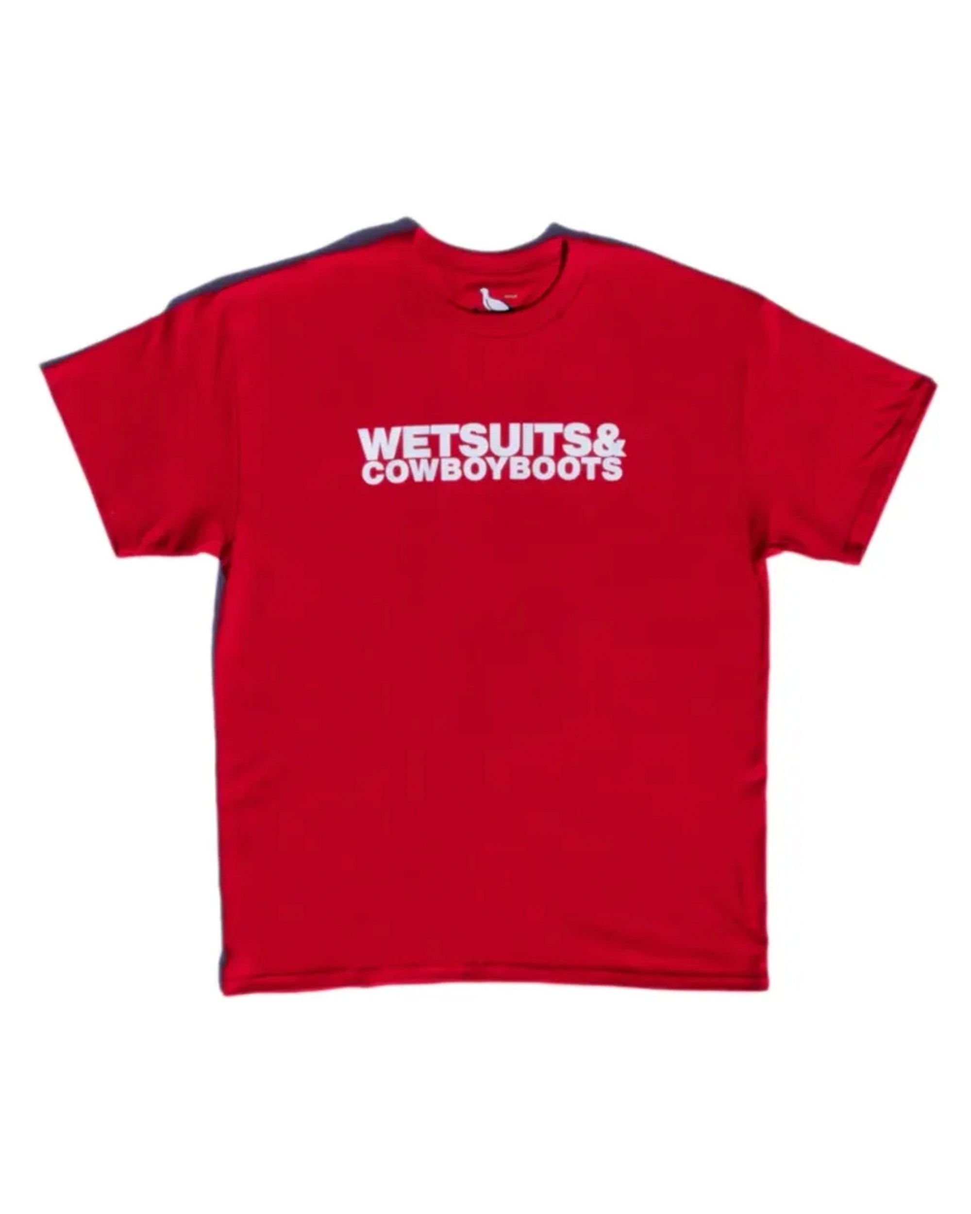 The Wet Suit & Cowboy Boots Tee by Ping Pong Surf Club is a red 100% cotton shirt with "WETSUITS & COWBOY BOOTS" boldly printed on the chest—perfect for fans of this iconic design.