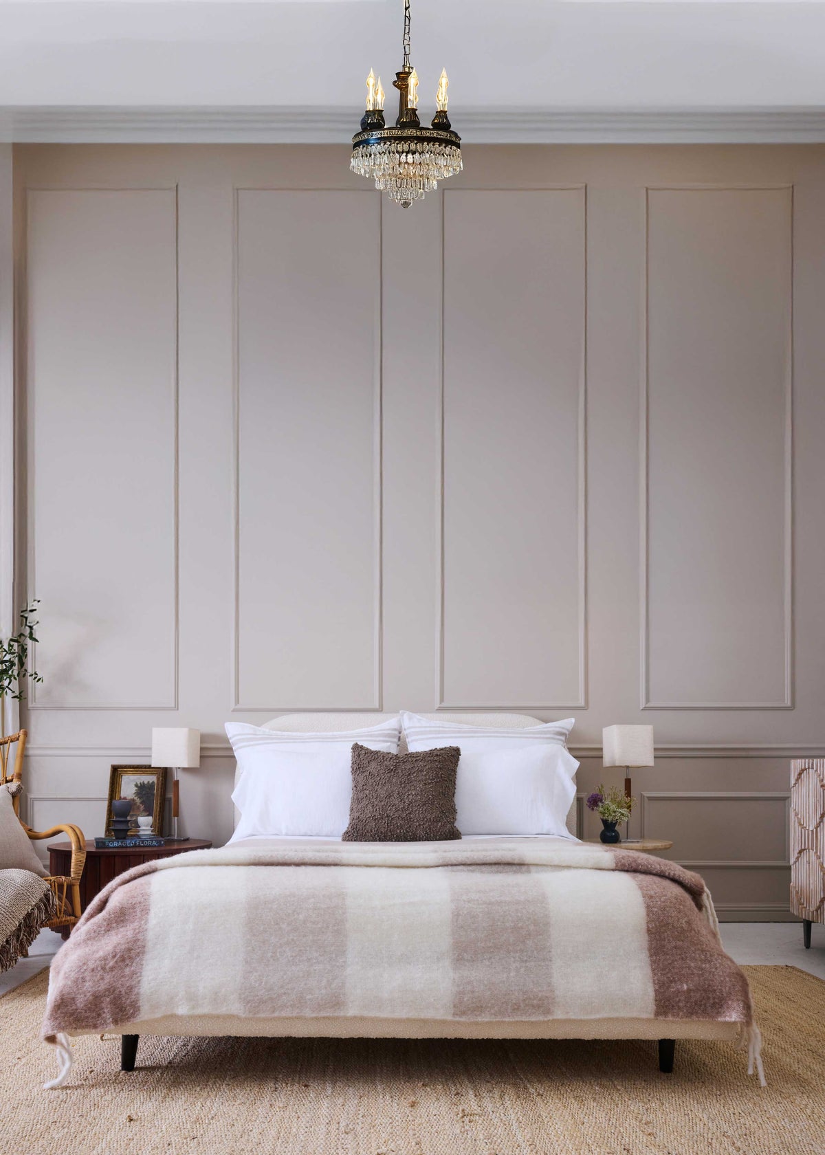 POM POM Whistler Throw adds cozy texture to a modern beige bedroom with a neatly made bed and white pillows.