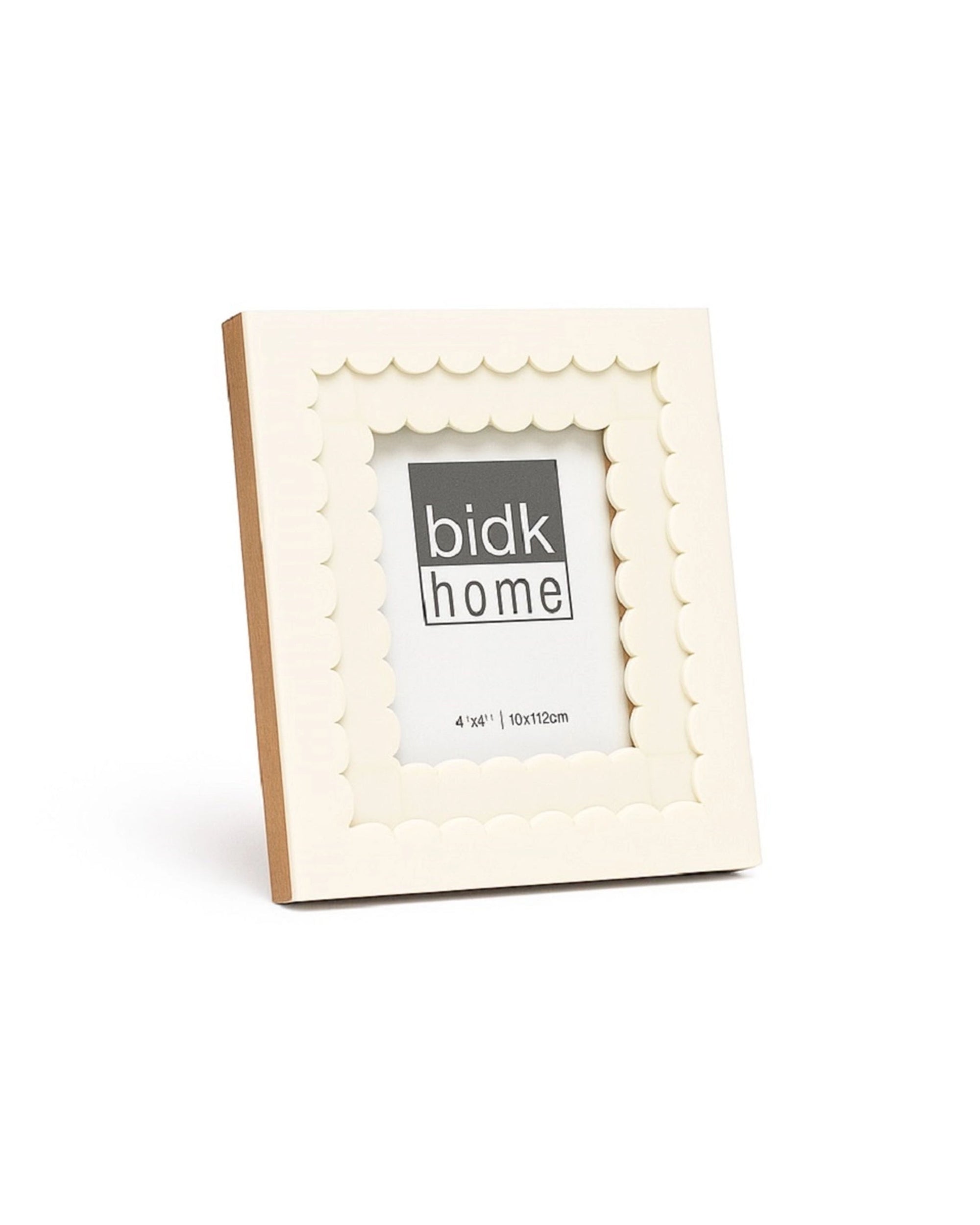 The 4x4 Floral Resin Frame by BIDK Home is a square, cream-colored photo frame with scalloped edges and a 4&quot; x 4&quot; display area, ideal for adding charm to your home decor.