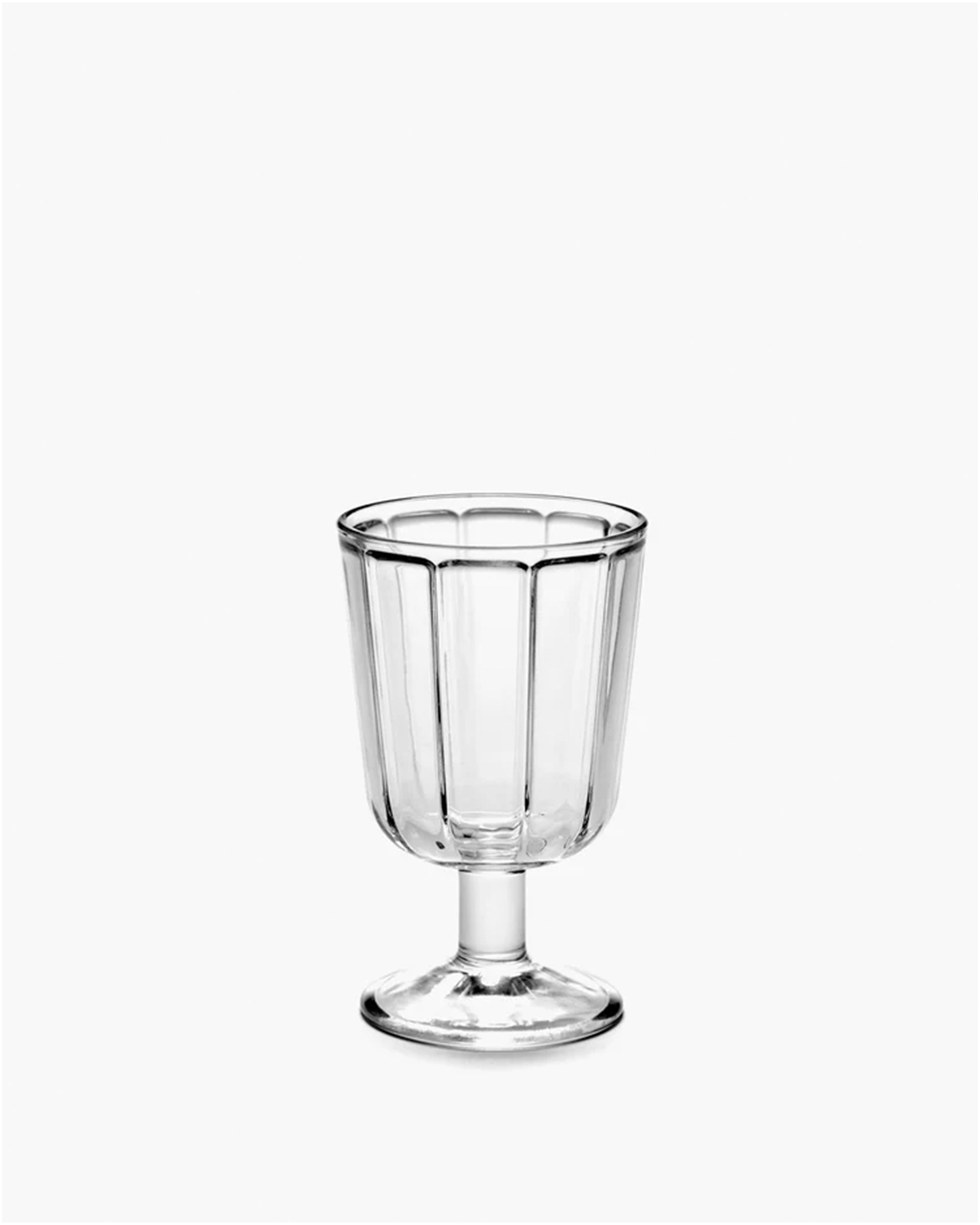 The Surface Glassware goblet by Serax is a clear, vertically ribbed designer piece featuring a short stem and wide base, shown against a plain white background.