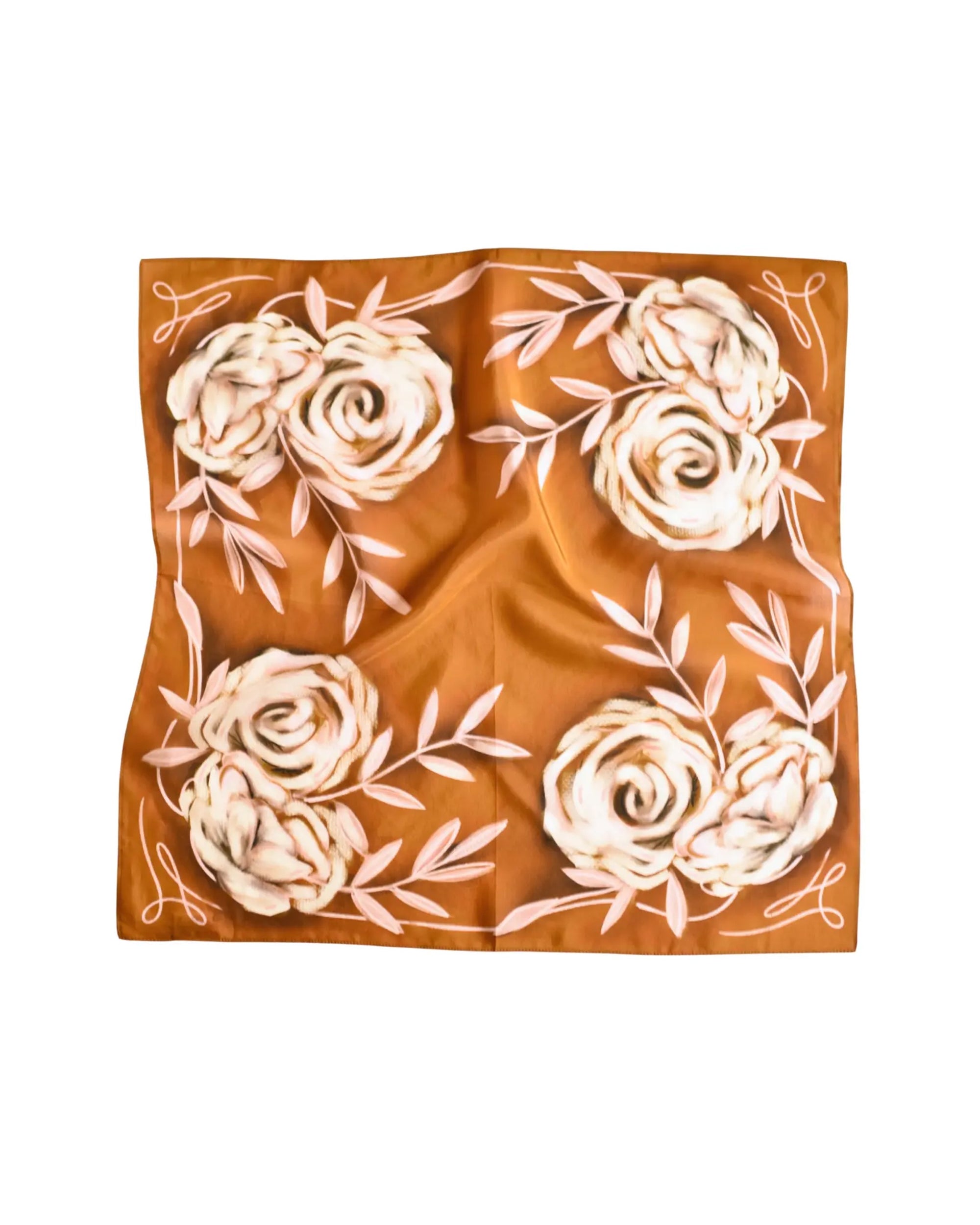 The Faire Wild Rag Silk Scarf features a warm brown background with cream floral patterns and pale leaf accents. Slightly wrinkled for a relaxed look, this silk and tencel scarf is a perfect cowgirl accessory.