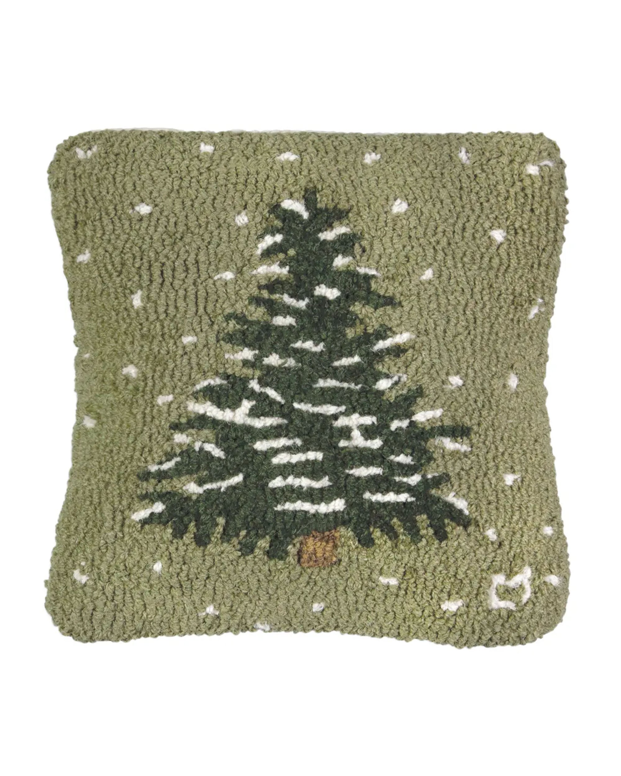 The Faire Christmas Flurries Frosted Tree Pillow is a square green hand-hooked wool pillow with a textured surface, showcasing a snow-covered Christmas tree and white dots for falling snow—ideal for festive holiday decor.