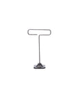 The Desk Wire Display Stand S by Faire features a hexagonal base and minimalist design, crafted from reclaimed steel wire to hold cards or small signs upright with a functional top loop.
