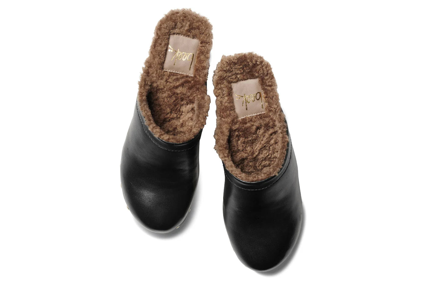 The Beek WOODPECKER clog is a black slip-on style featuring plush brown faux fur lining, shown from above on a white background.