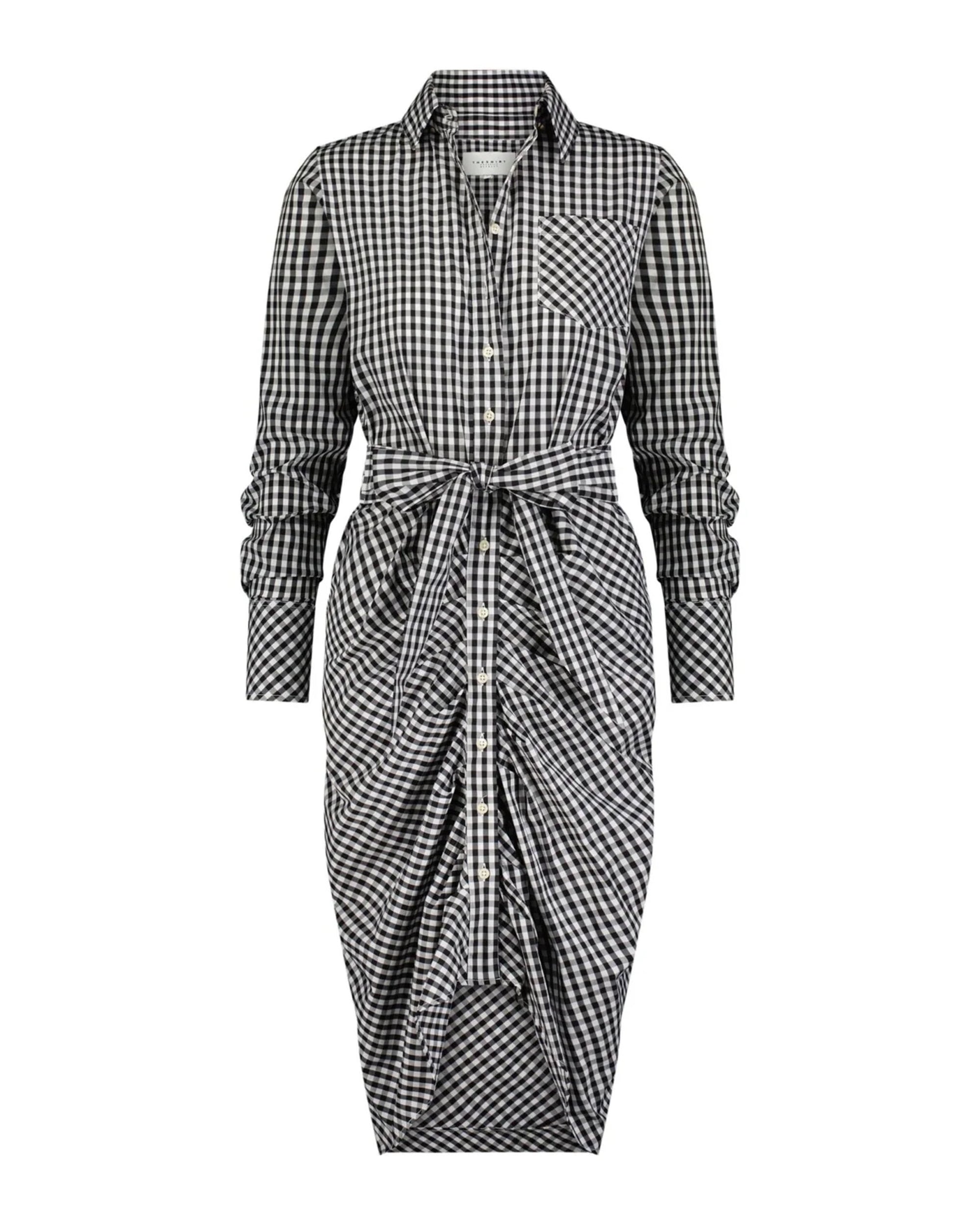 The Wrap Front Dress by THE SHIRT is a black and white gingham long sleeve shirt dress with a collar, front pocket, and waist tie, creating a gathered, draped effect on the midi skirt.