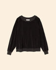 The Xirena Hopper Sweatshirt is a black long-sleeve pullover with a crew neck, ribbed cuffs and hem, made from a soft cotton blend velour, shown against a neutral beige background.