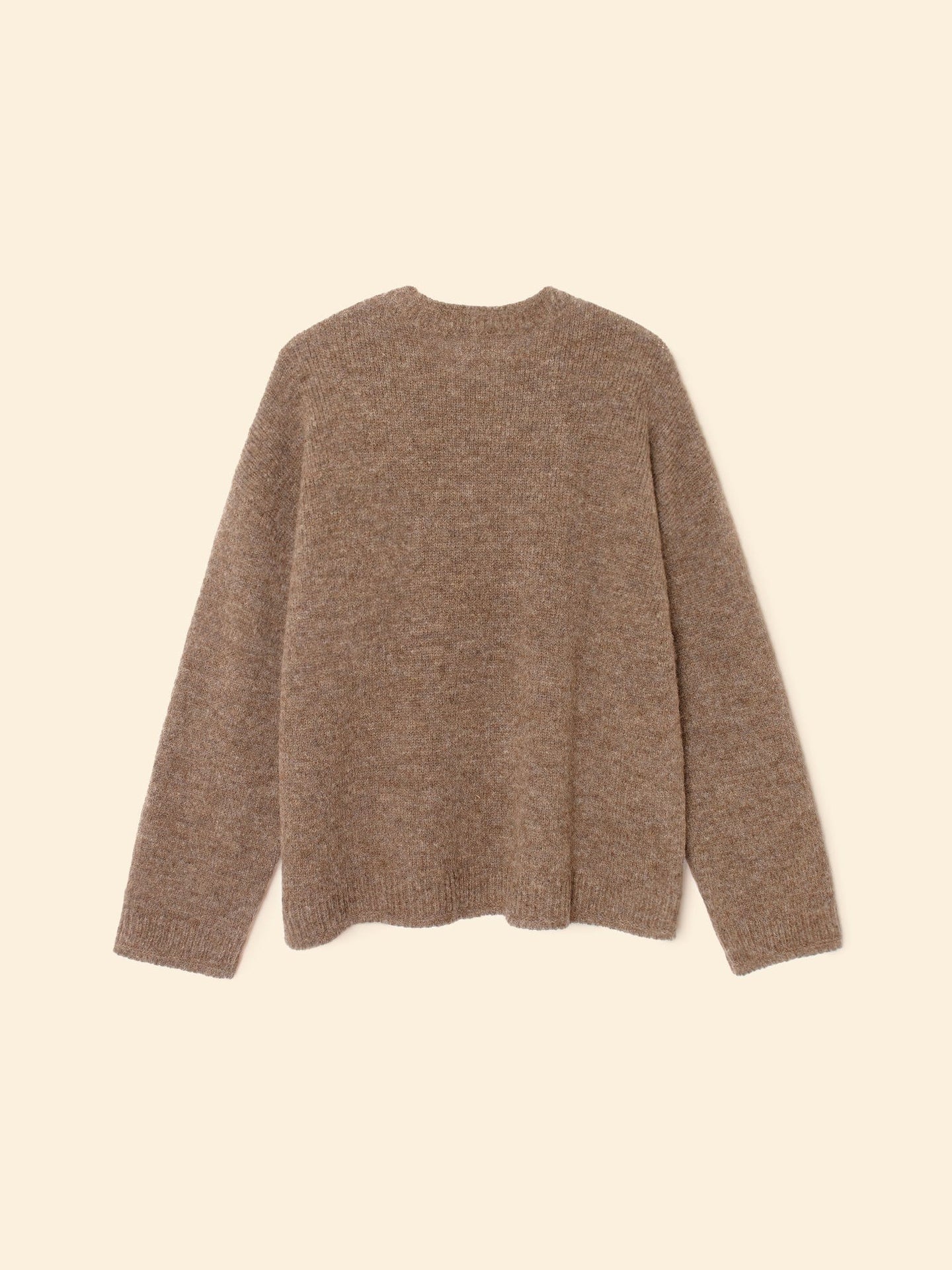 The Julien Sweater by Xirena, a brown long-sleeve crew-neck pullover, is laid flat on a beige background with its back side visible.