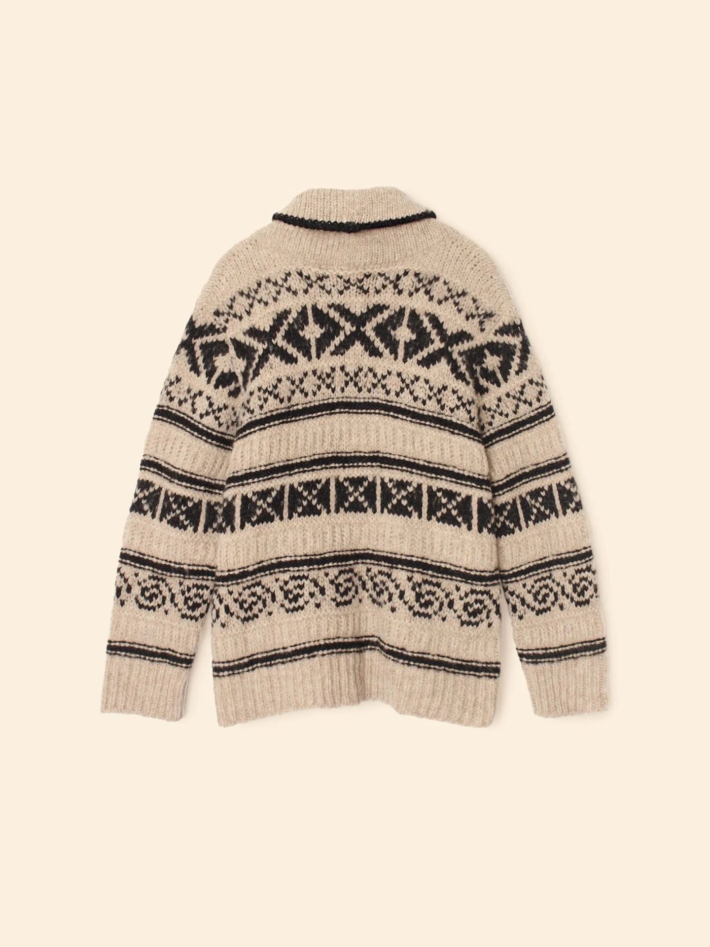 The Xirena Vail Cardigan is a beige alpaca sweater featuring black geometric and diamond-shaped patterns in horizontal rows, shown flat with the back facing up against a neutral background.