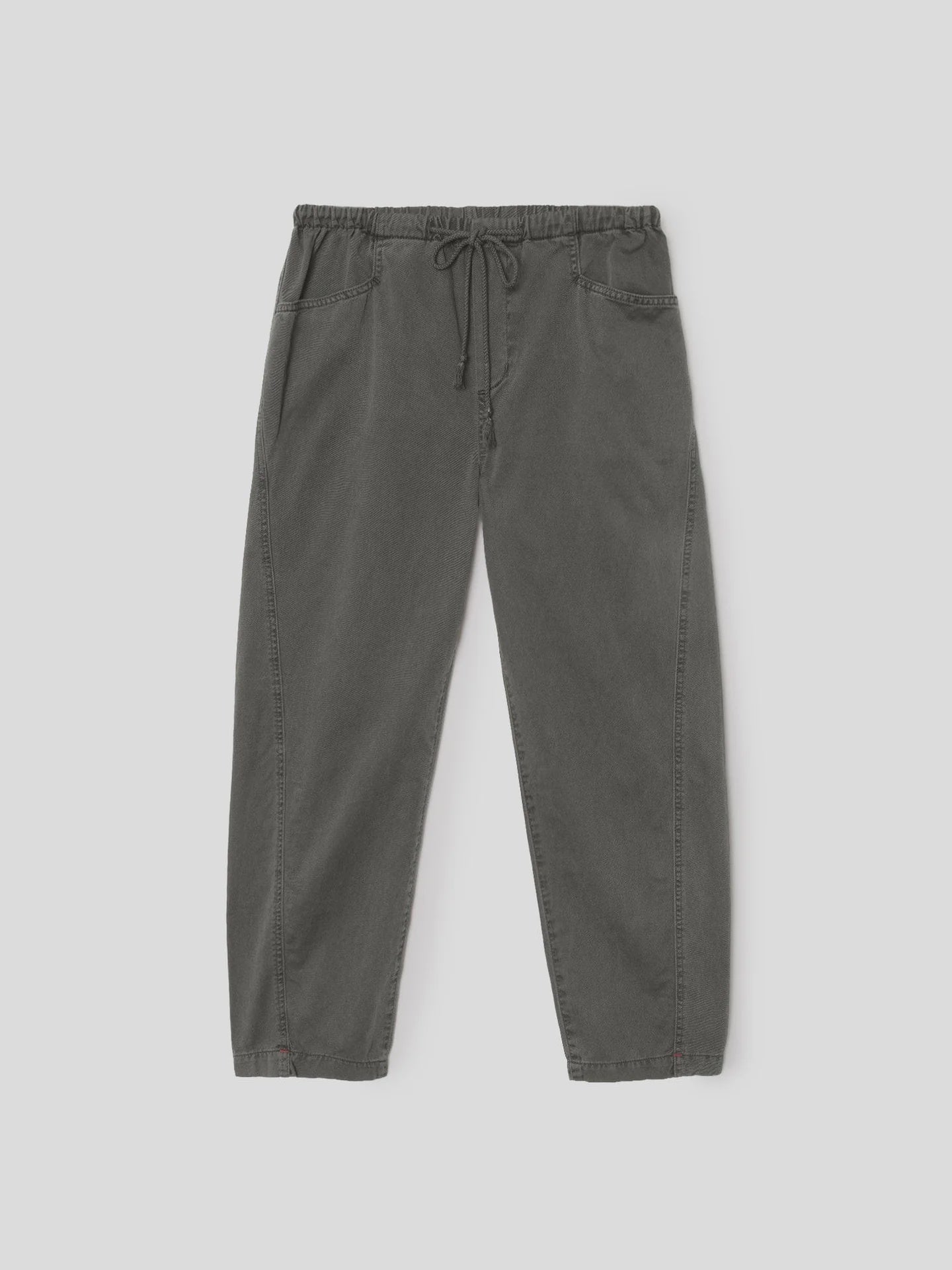 The Xirena Baxter Pant is a pair of loose-fitting, charcoal gray cropped pull-on pants in vintage washed cotton twill with an elastic drawstring waist, shown on a plain light gray background.