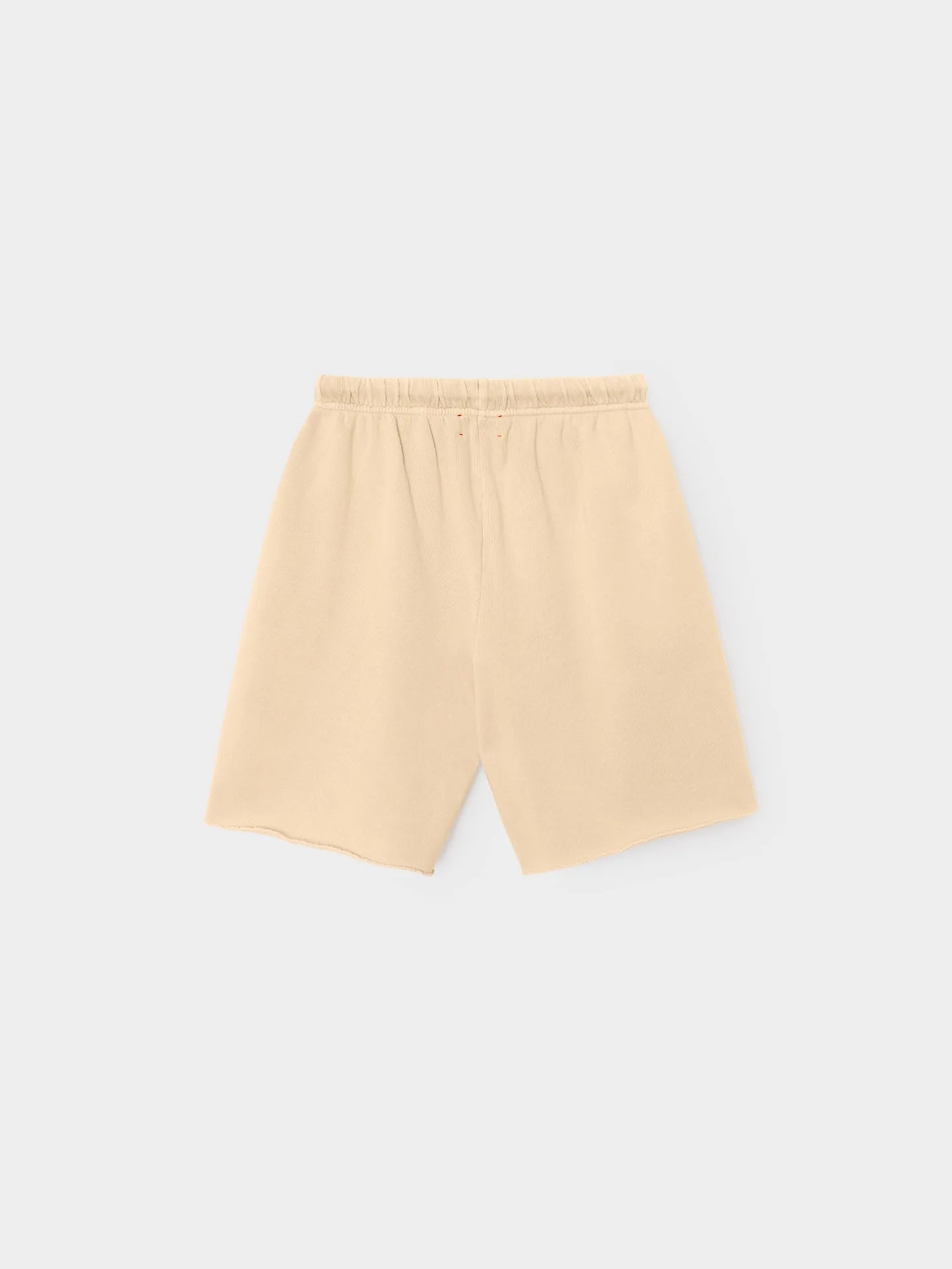 The Rocco Short by Xirena is a beige, knee-length French terry sweatshort with an elastic waistband. Displayed flat on a light gray background, these vintage-washed shorts have a minimal design and no visible pockets or embellishments.