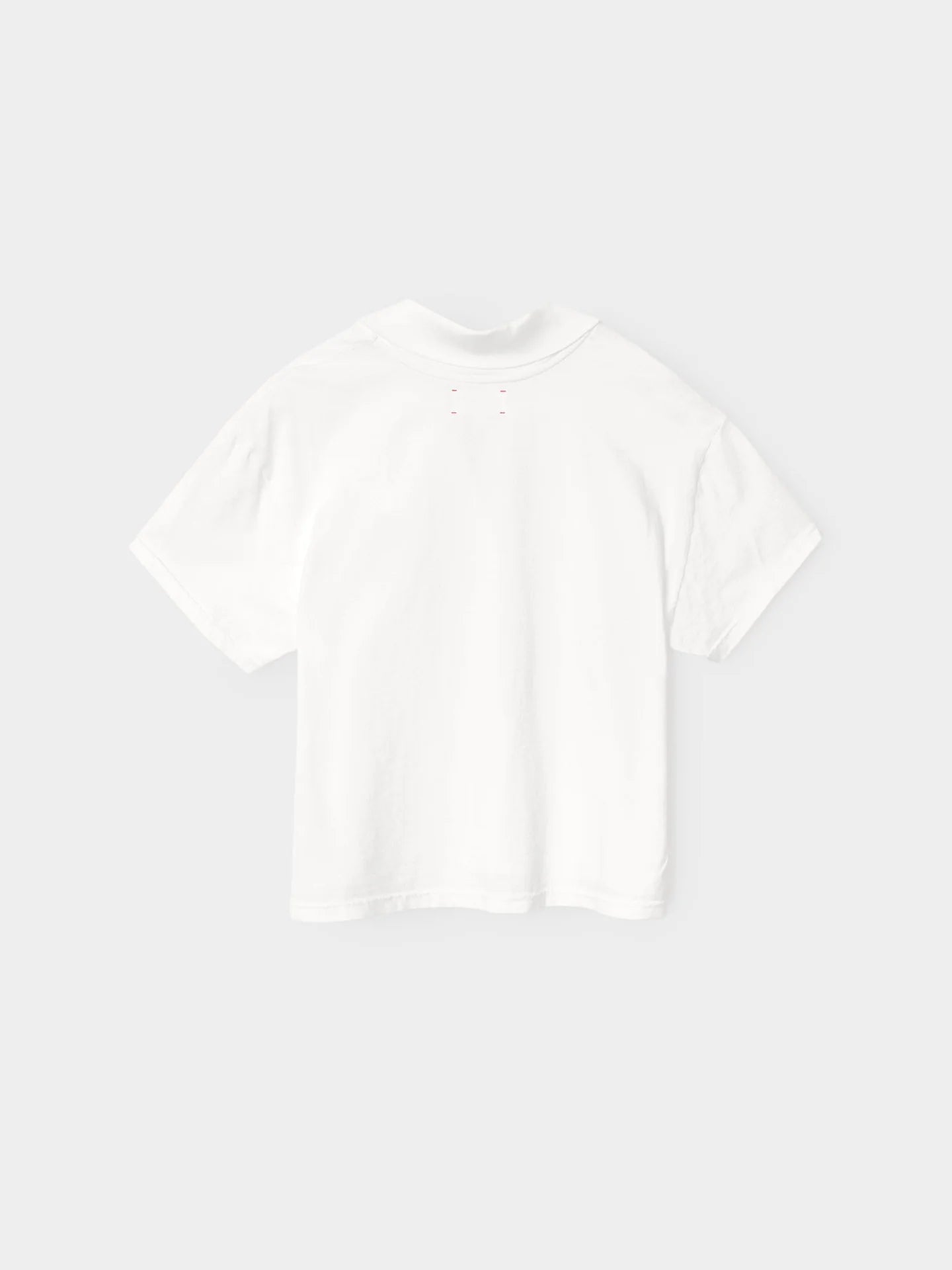 The Xirena Spencer Tee, a relaxed-fit plain white short-sleeve t-shirt, is shown laid flat and viewed from the back against a light gray background.