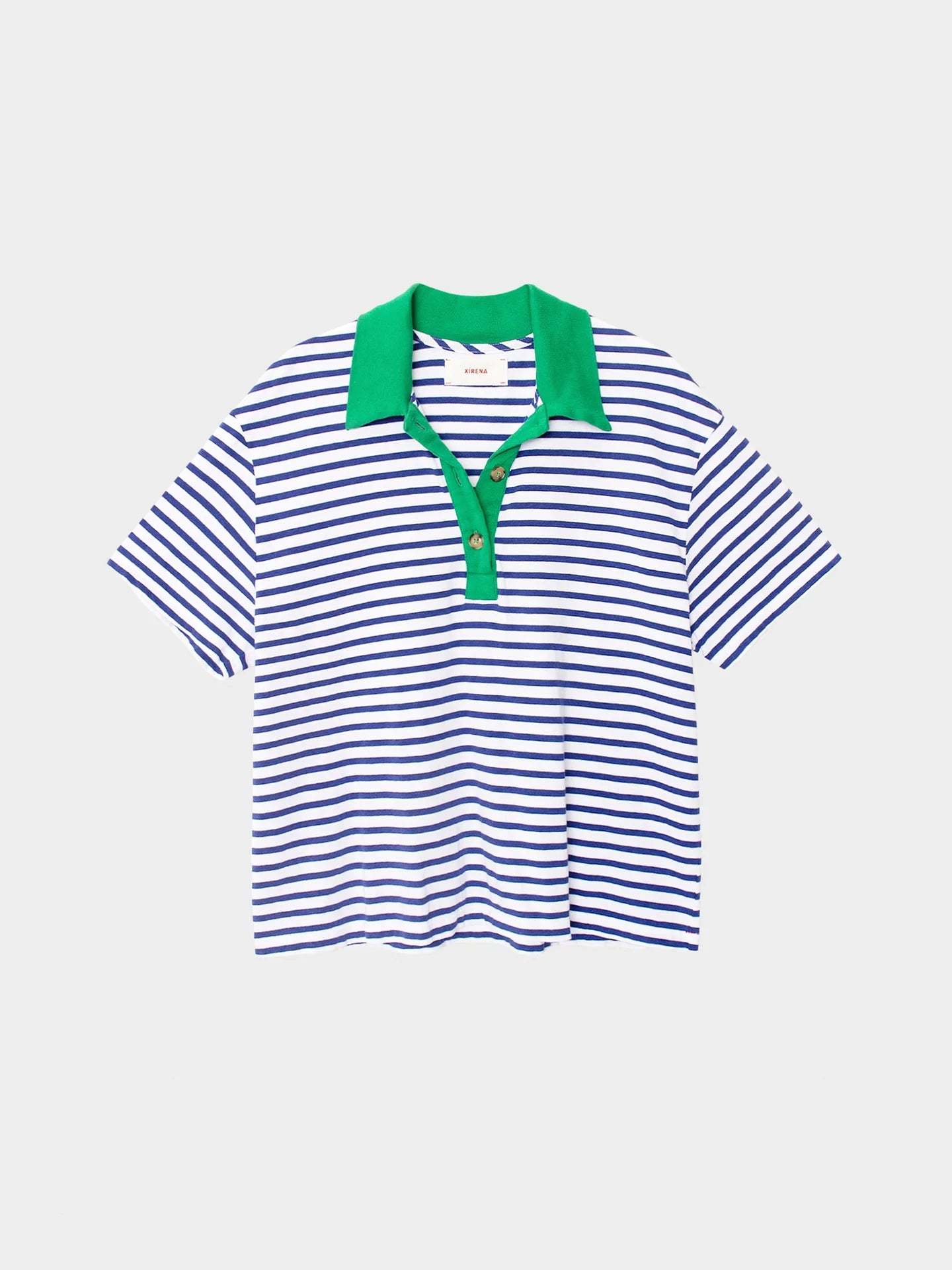 The Xirena Kellie Top is a women's short sleeve polo made from striped cotton jersey with blue and white horizontal stripes, a green collar, and a three-button green placket. Shown on a plain light background.