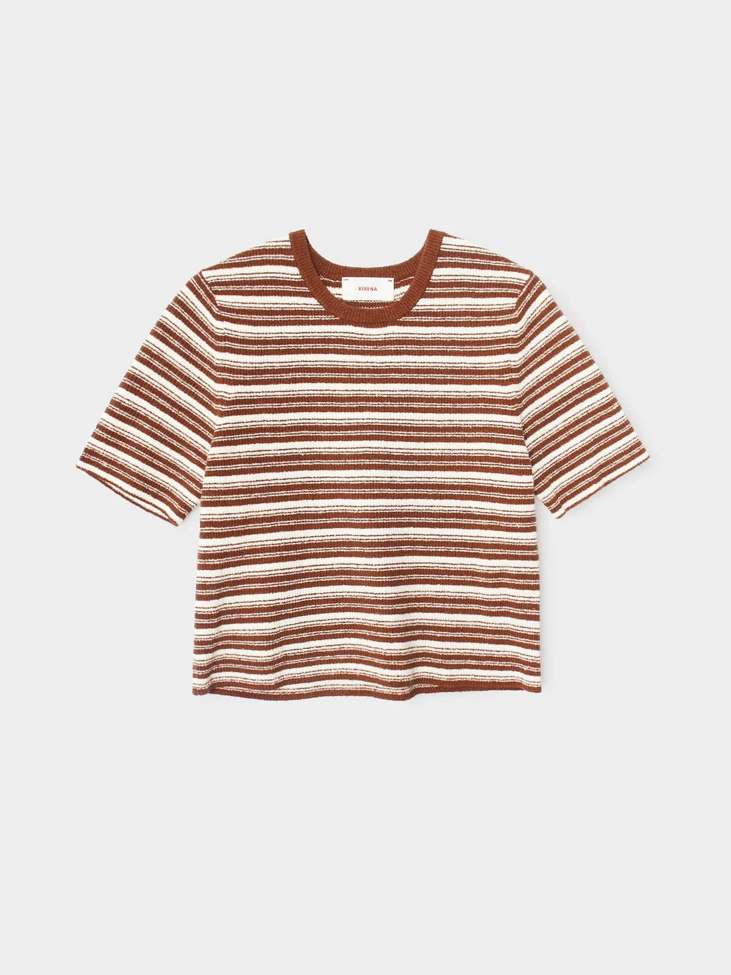 The Kelsey Top by Xirena is a short-sleeve, ribbed knit crew neck T-shirt with horizontal brown, white, and beige stripes in stretch cotton boucle and a solid brown neckline, shown on a white background.