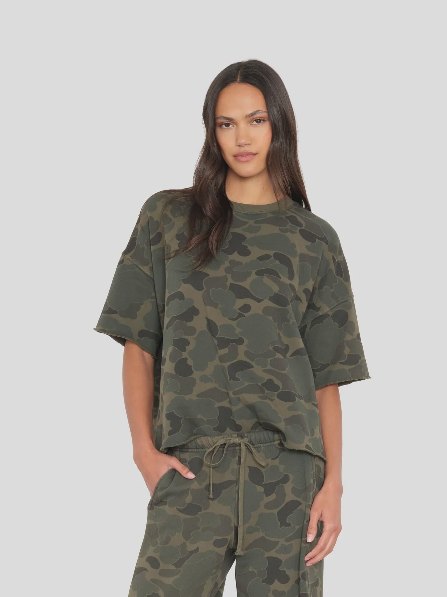 Xirena Romeo Tee in soft fabric, relaxed fit; woman wears it casually with one hand in her pocket.