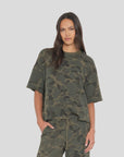 Xirena Romeo Tee in soft fabric, relaxed fit; woman wears it casually with one hand in her pocket.