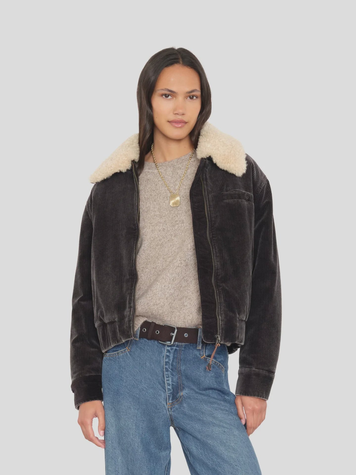 Xirena Bradley Jacket in beige paired with a cozy sweater and jeans, styled with layered necklaces for a relaxed look.