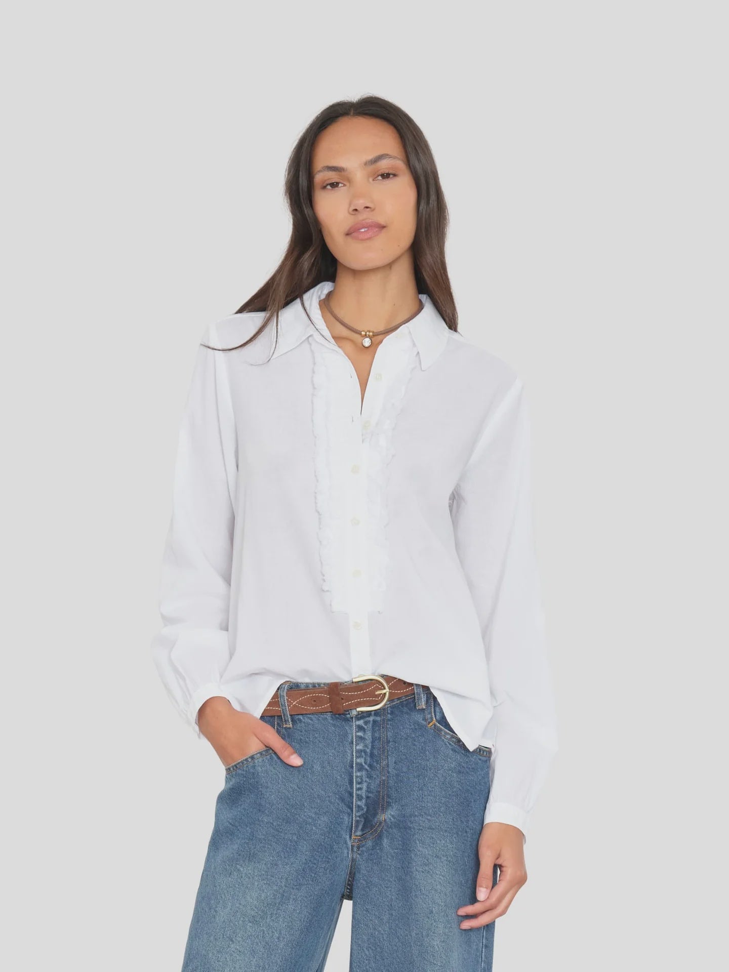 Xirena Amanda lightweight cotton shirt in white with blue jeans, styled casually against a plain background.