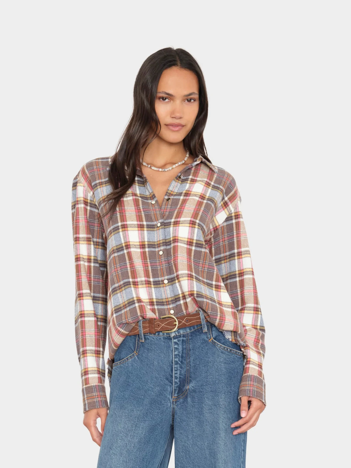 Xirena Beau Shirt in Canyon Brown styled with blue jeans, shown on model against a simple background.
