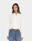 Ivory Beau Shirt by Xirena paired with blue jeans, modern casual look against a simple light background.
