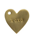 The HomArt Brass Tag XOXO is a hand-stamped, heart-shaped brass tag with a small hole at the top left and "XOXO" engraving—ideal as a unique gift tag or sentimental present.