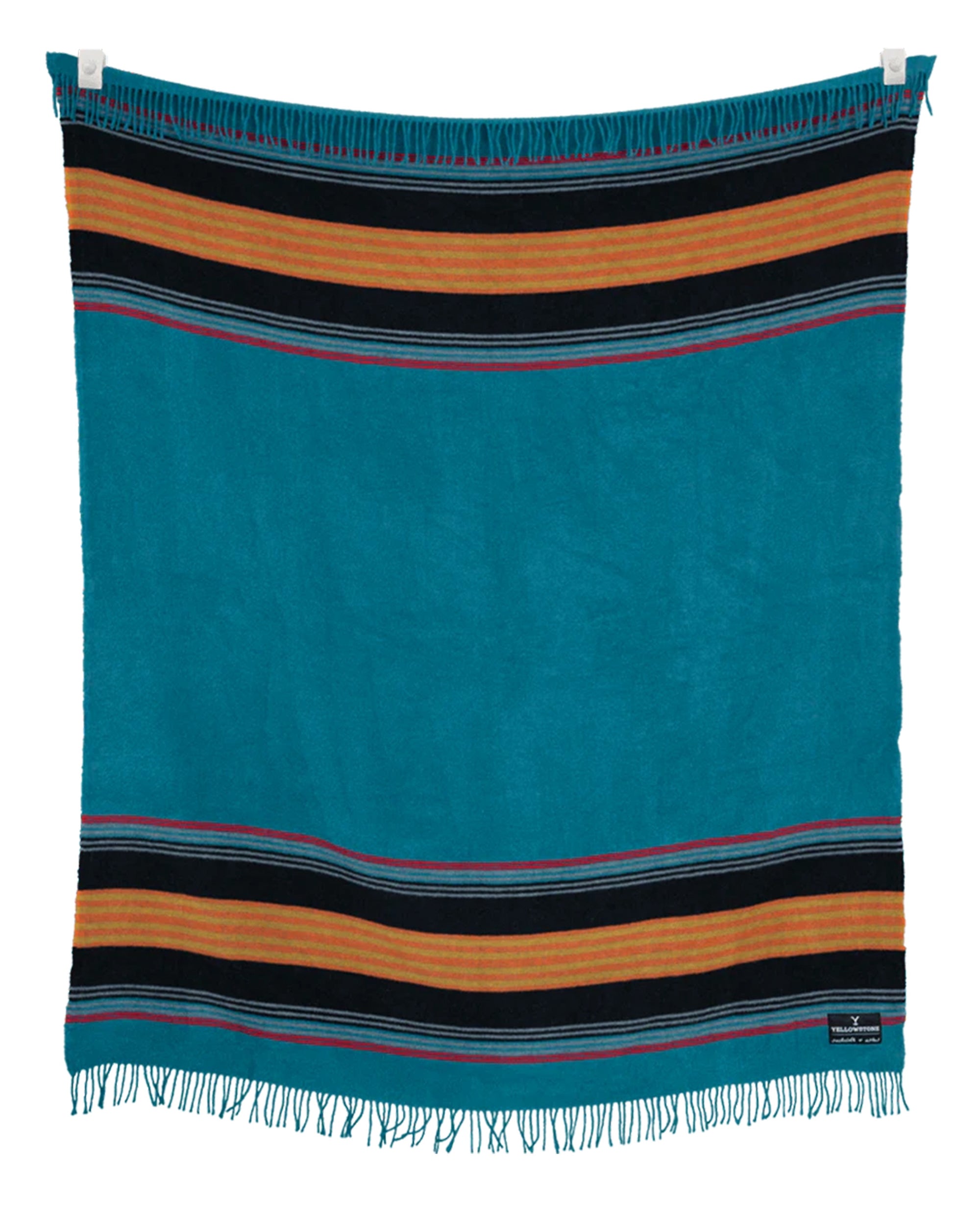 The Sackcloth & Ashes/Yellowstone Teal blanket by Sackcloth & Ashes, made from recycled materials, displays turquoise with black and gold stripes at the top and bottom, small fringe edges, and is shown hanging against a white background.