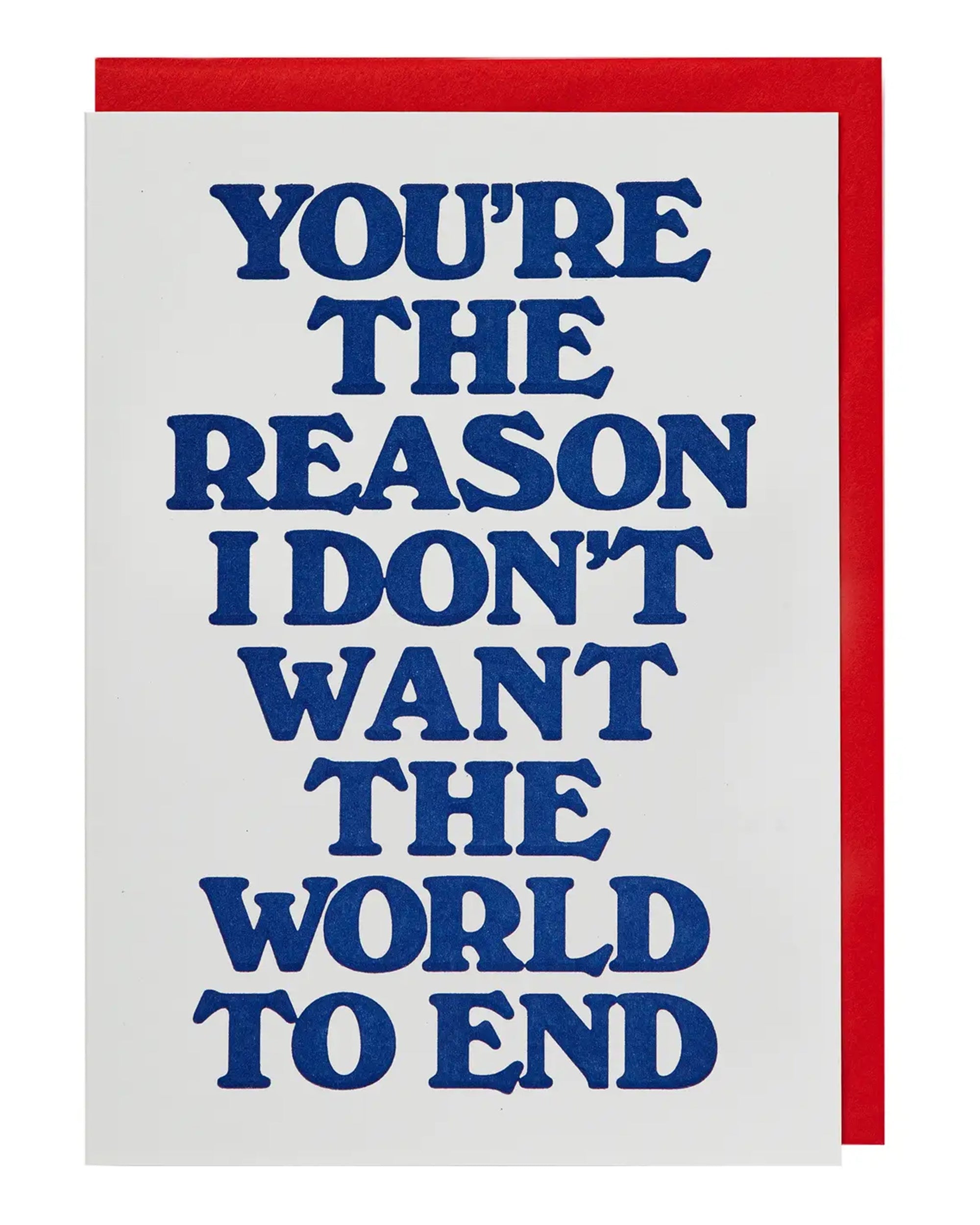 The Faire "You're the Reason Card" features bold blue text on a white background reading, "You're the reason I don't want the world to end." This witty greeting card comes with a partially visible red envelope.