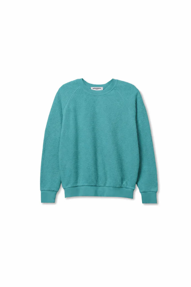 The Perfectwhitetee Ziggy Reverse LS Sweatshirt in turquoise cotton fleece features bracelet-length sleeves, ribbed cuffs, and a ribbed hem, shown on a white background.