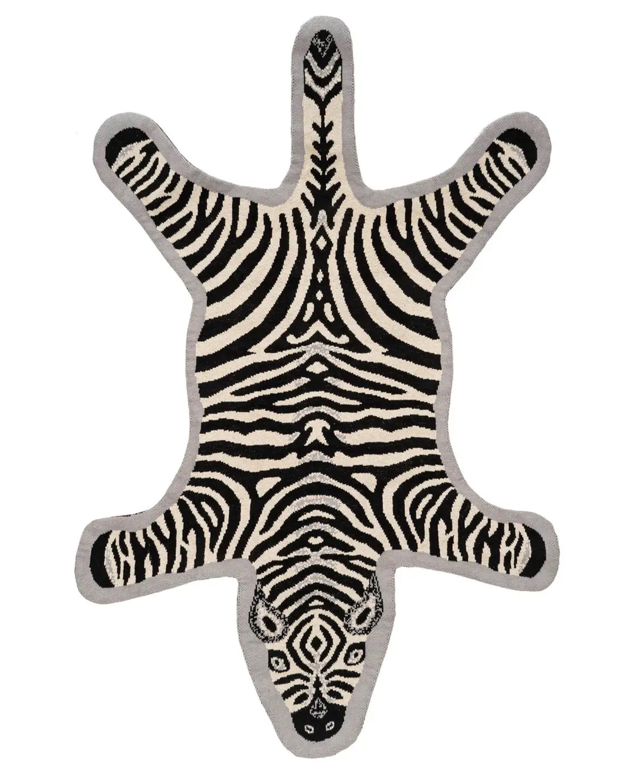 The Indaba Zebra Knit Rug 3x5 features a stylized black and white zebra design with detailed face, spread-out legs, and a light gray border—perfect for unique kids’ room decor.
